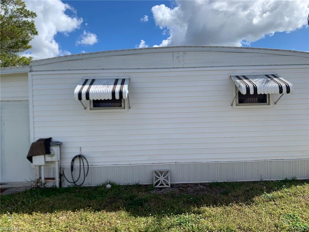 9322 Pitt Road Bonita Springs, FL 34135 - Photo 4 of 24 a front view of a house with garden