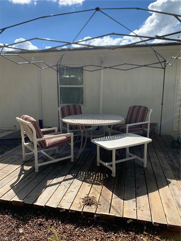 9322 Pitt Road Bonita Springs, FL 34135 - Photo 5 of 24 a balcony with a table and chairs