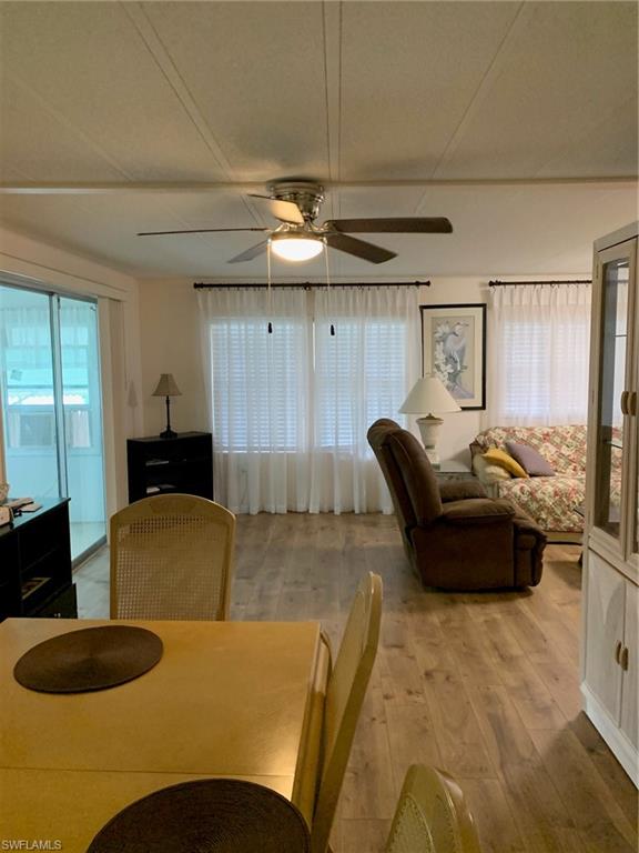 9322 Pitt Road Bonita Springs, FL 34135 - Photo 9 of 24 a living room with furniture and a chandelier