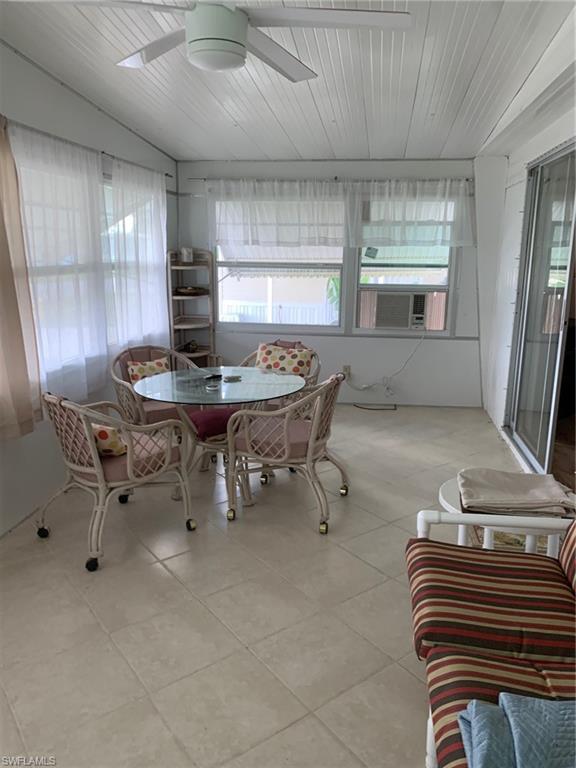 9322 Pitt Road Bonita Springs, FL 34135 - Photo 10 of 24 a kitchen with a sink a stove and a refrigerator