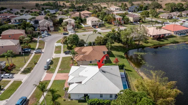 an aerial view of residential houses with outdoor space and swimming pool