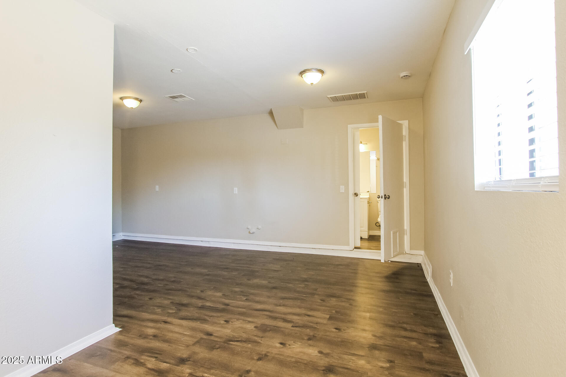 7130 West Merrell Street Phoenix, AZ 85033 - Photo 12 of 21 a view of a hallway with wooden floor
