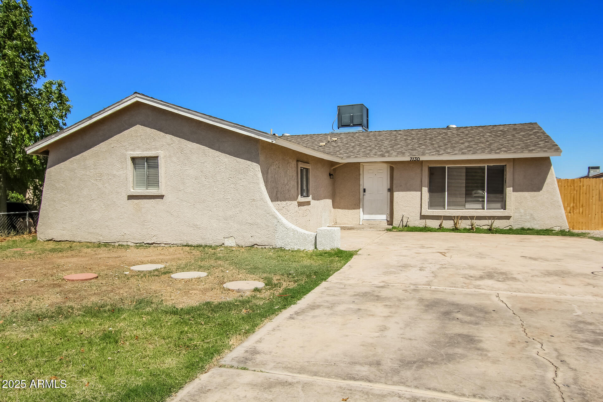 7130 West Merrell Street Phoenix, AZ 85033 - Photo 2 of 21 a front view of a house with yard