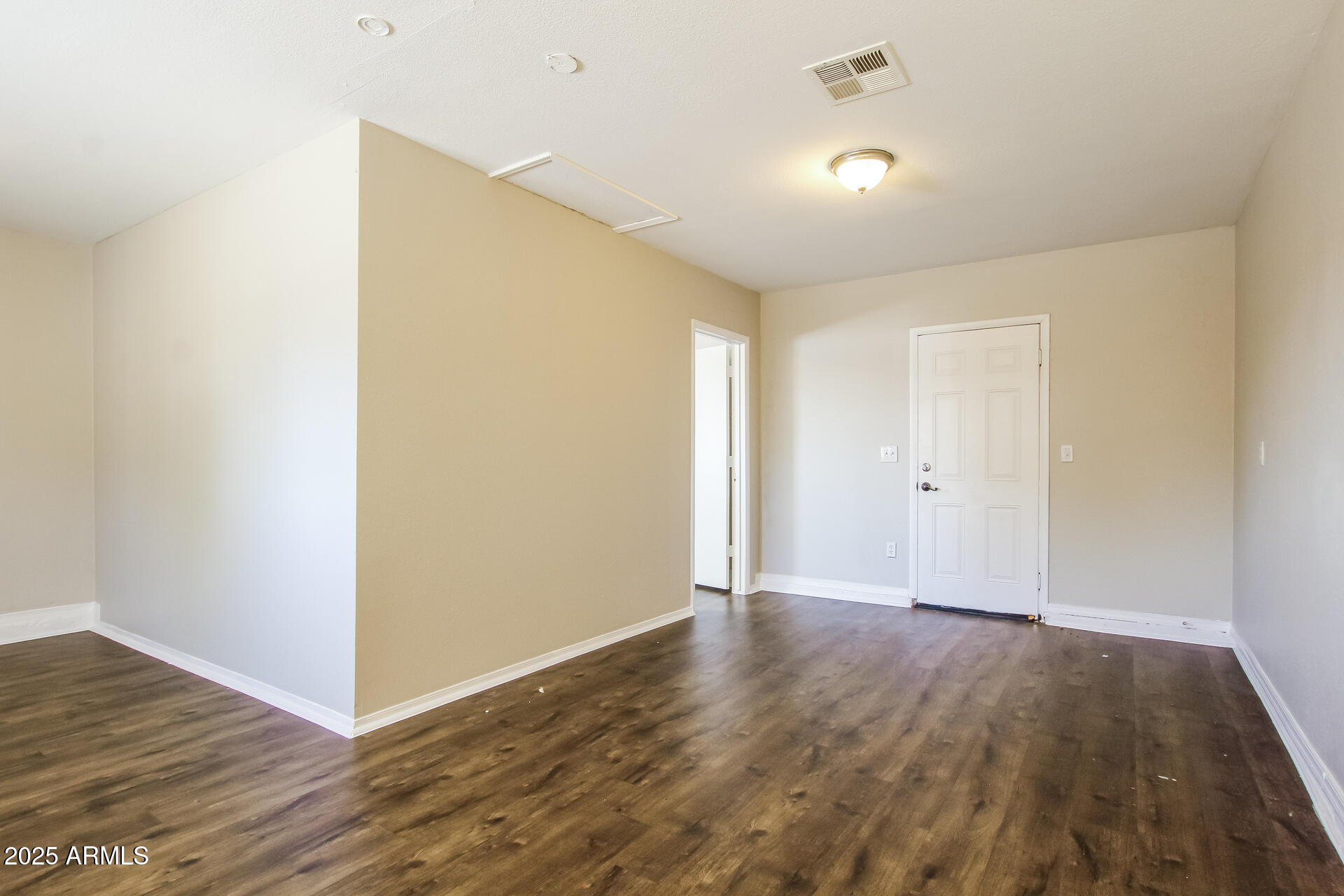 7130 West Merrell Street Phoenix, AZ 85033 - Photo 3 of 21 a view of an empty room with wooden floor