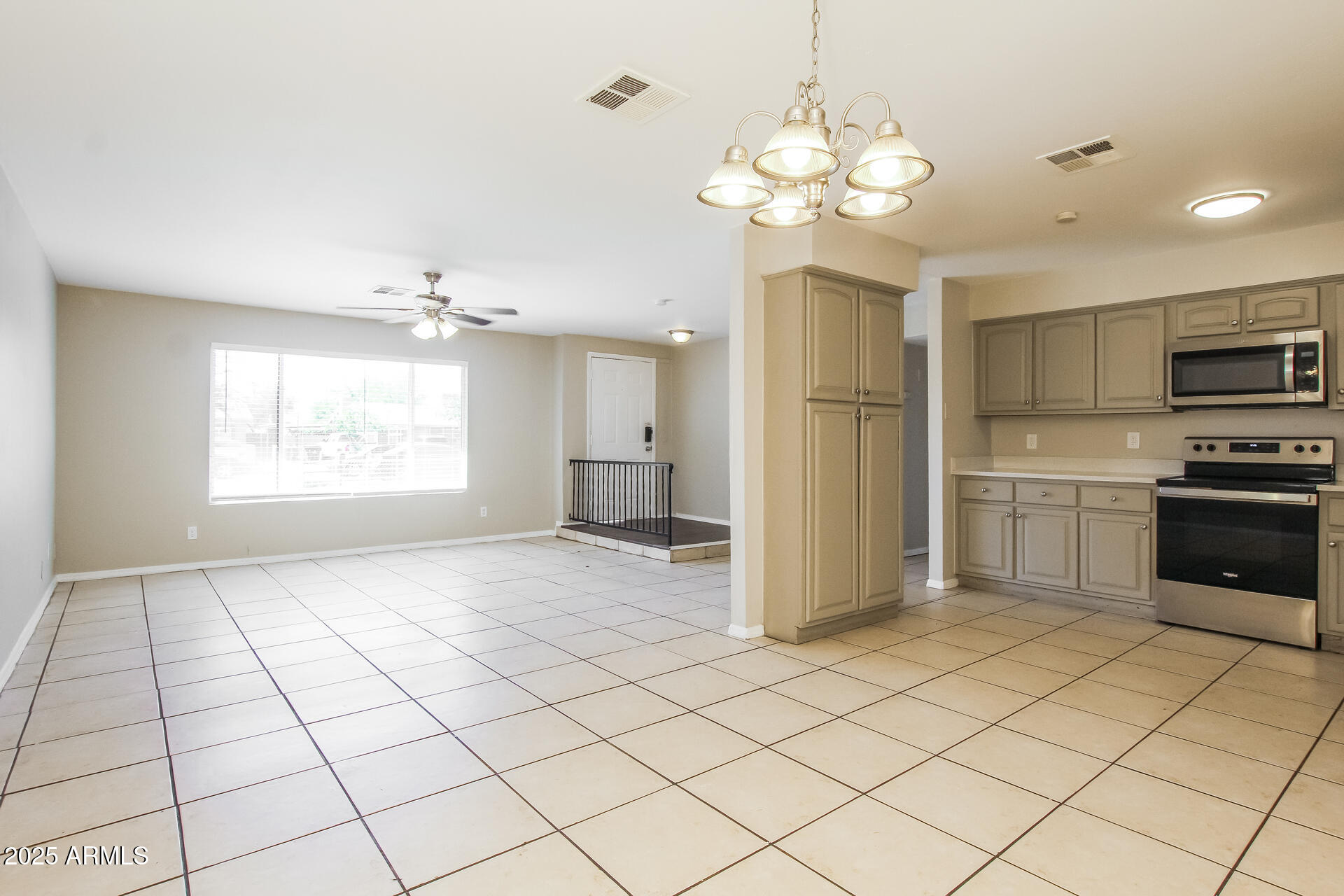 7130 West Merrell Street Phoenix, AZ 85033 - Photo 5 of 21 a view of a kitchen with a stove cabinets and a chandelier