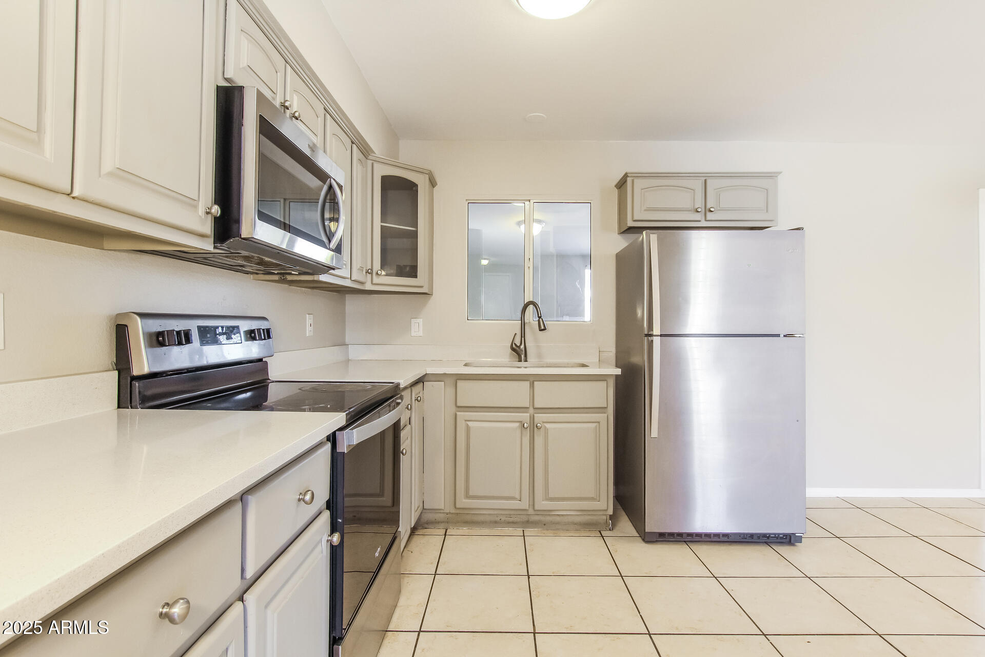 7130 West Merrell Street Phoenix, AZ 85033 - Photo 7 of 21 a kitchen with stainless steel appliances granite countertop a refrigerator sink and stove