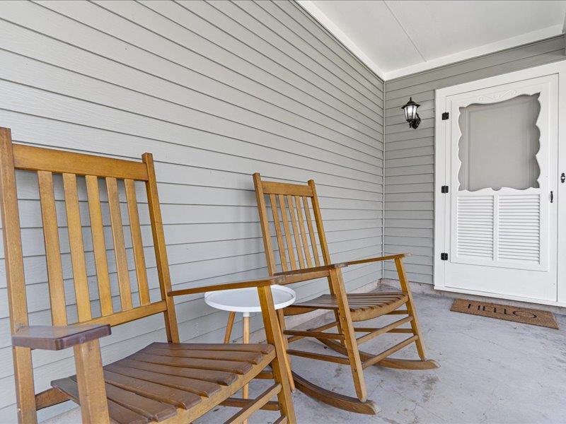 1312 Hyman Lane Austin, TX 78742 - Photo 5 of 36 The property features a front porch with light gray siding and a white screen door
