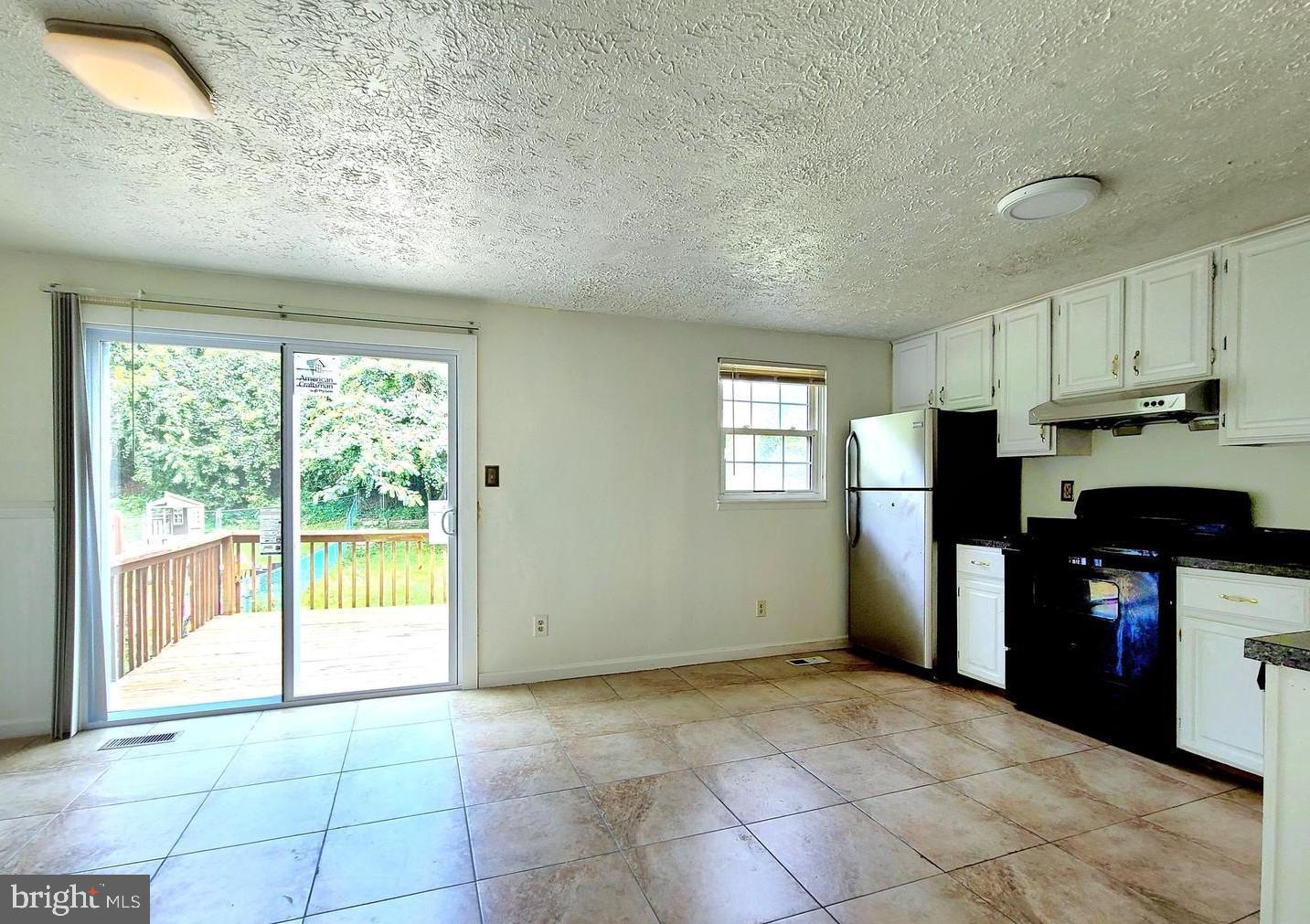 3954 Link Avenue Nottingham, MD 21236 - Photo 4 of 8 Eat-In Kitchen w/ Sliders to Deck & Fenced Yard
