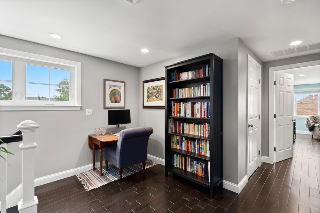 36 River Street, Unit 2 Arlington, MA 02474 - Photo 17 of 32 a work room with furniture and a book shelf