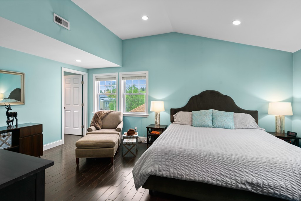 36 River Street, Unit 2 Arlington, MA 02474 - Photo 22 of 32 a bedroom with a bed and wooden floor