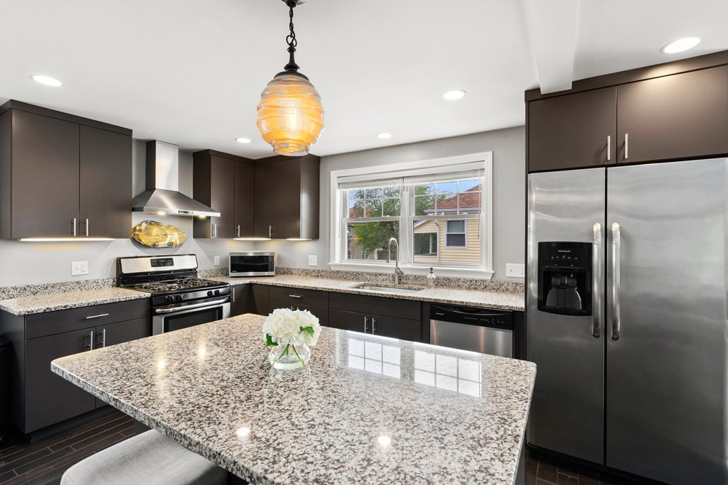 36 River Street, Unit 2 Arlington, MA 02474 - Photo 6 of 32 a kitchen with stainless steel appliances granite countertop a stove refrigerator and cabinets