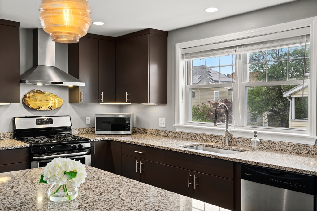 36 River Street, Unit 2 Arlington, MA 02474 - Photo 7 of 32 a kitchen with stainless steel appliances a stove a sink and a granite counter tops