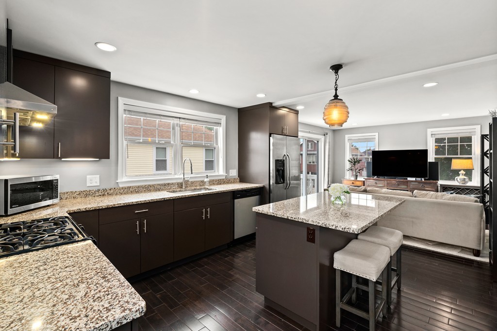 36 River Street, Unit 2 Arlington, MA 02474 - Photo 8 of 32 a large kitchen with a table and chairs
