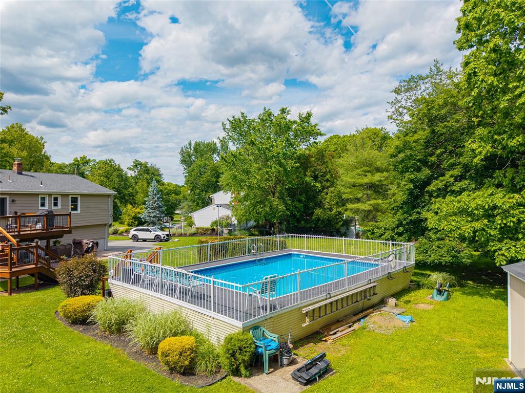 55 Marcia Road Ringwood, NJ 07456 - Photo 36 of 42 a view of a swimming pool with a patio and a yard