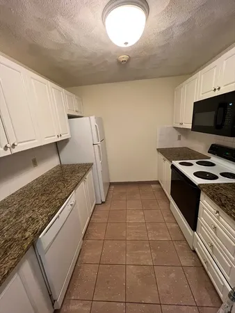 a kitchen with a sink a stove and a microwave