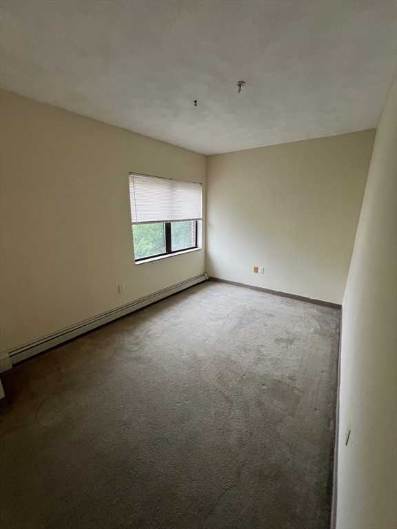 373 Highland Avenue, Unit 301 Somerville, MA 02144 - Photo 4 of 10 a view of an empty room with a window