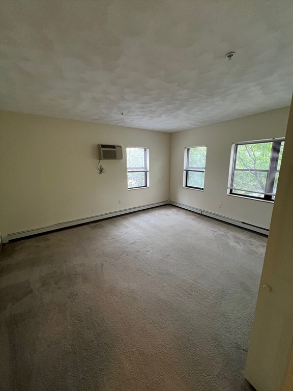373 Highland Avenue, Unit 301 Somerville, MA 02144 - Photo 6 of 10 an empty room with windows