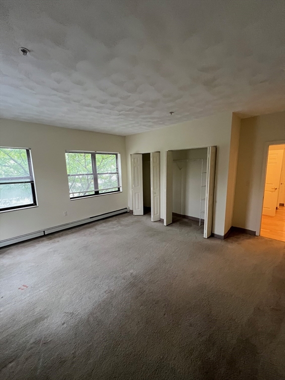 373 Highland Avenue, Unit 301 Somerville, MA 02144 - Photo 7 of 10 an empty room with windows