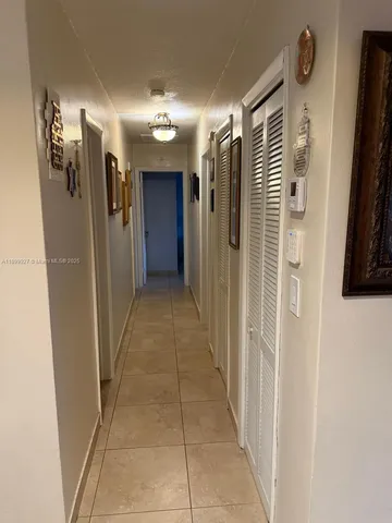 a bedroom with a bed and painting on the wall