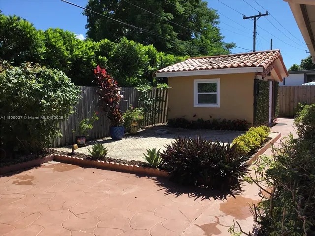 a vase of flowers sitting on a floor