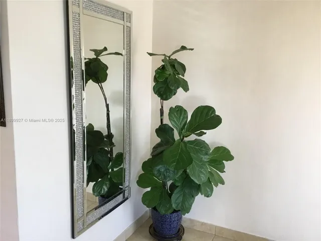 a view of a dining room with a table and chairs