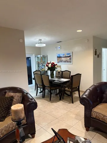 a view of a dining room with furniture and window
