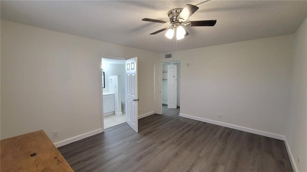 9273 Southwest 8th Street, Unit 109 Boca Raton, FL 33428 - Photo 6 of 20 wooden floor in an empty room with a window