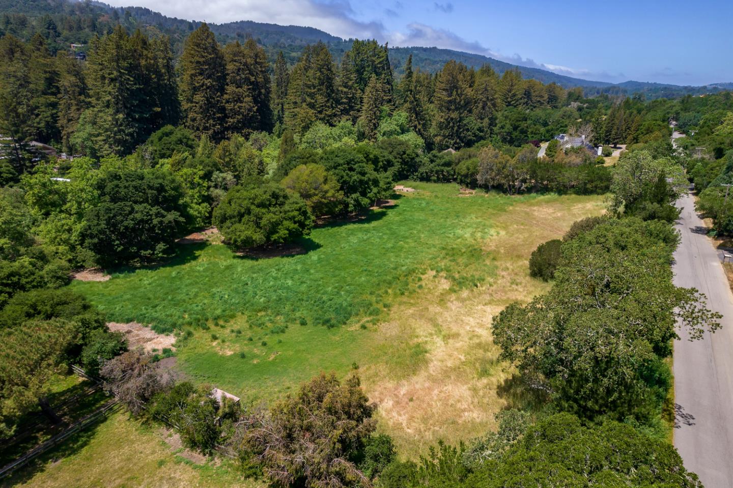 0 Farm Road Woodside, CA 94062 - Photo 3 of 14 a view of a lush green hillside and a building in the background