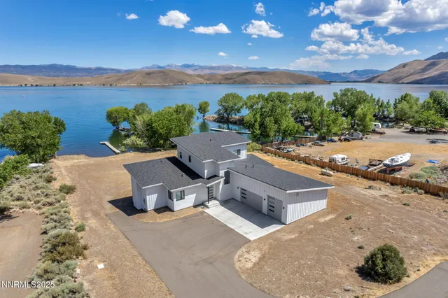 a view of a house with a yard and potted plants