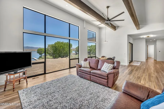 a large kitchen with kitchen island a large counter top stainless steel appliances and cabinets