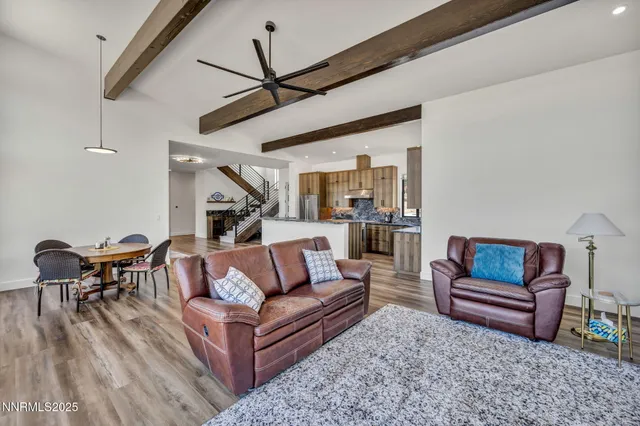 a kitchen with stainless steel appliances granite countertop a refrigerator a stove a sink dishwasher and a refrigerator with wooden floor