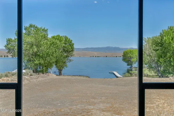 a bathroom with a granite countertop sink a mirror and shower