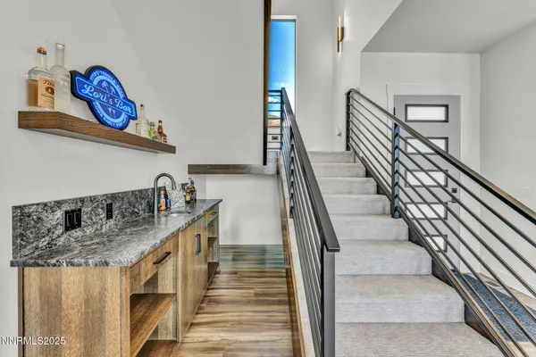 a bathroom with a granite countertop sink and a toilet