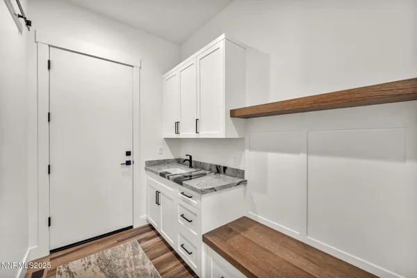 a view of a house with a yard and potted plants