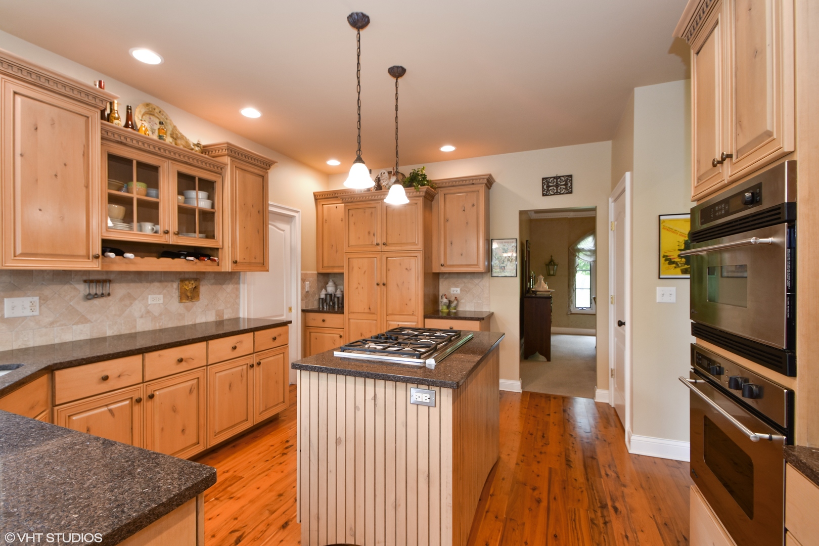 26010 West Airport Road Minooka, IL 60447 - Photo 18 of 28 a kitchen with stainless steel appliances kitchen island granite countertop a stove a sink dishwasher and a refrigerator with wooden floor