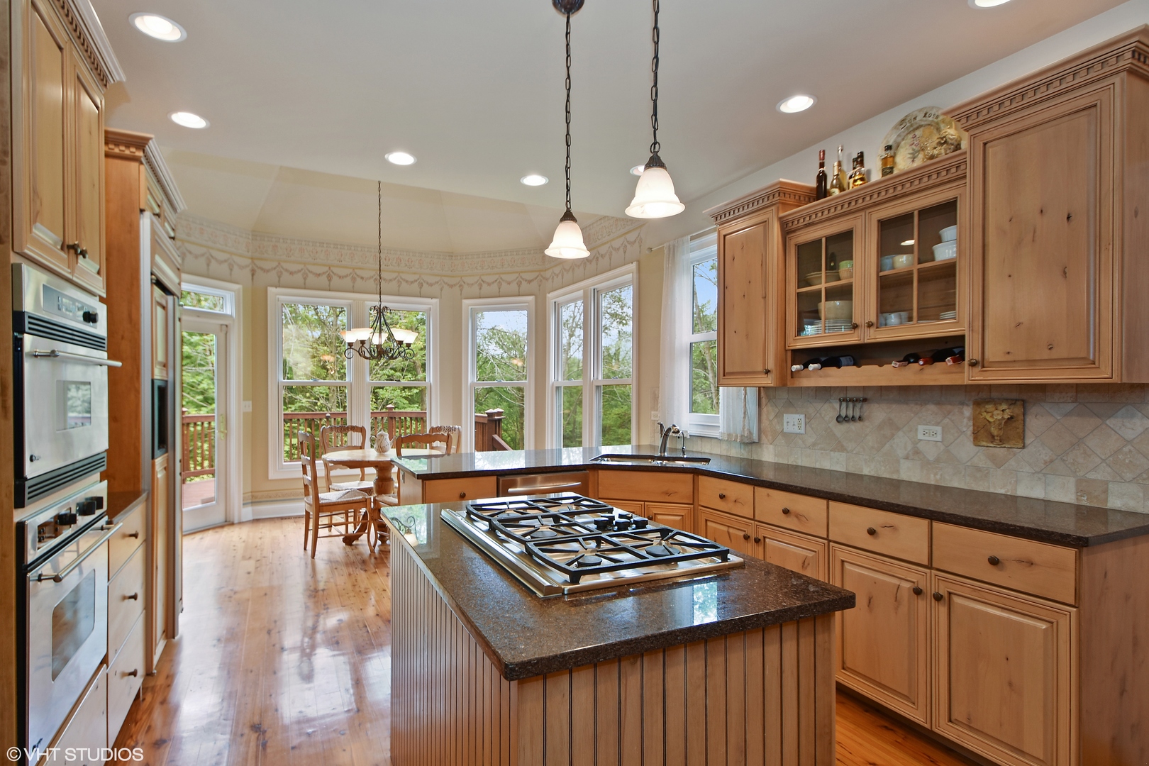 26010 West Airport Road Minooka, IL 60447 - Photo 9 of 28 a kitchen with stainless steel appliances a stove a sink cabinets and a dining table