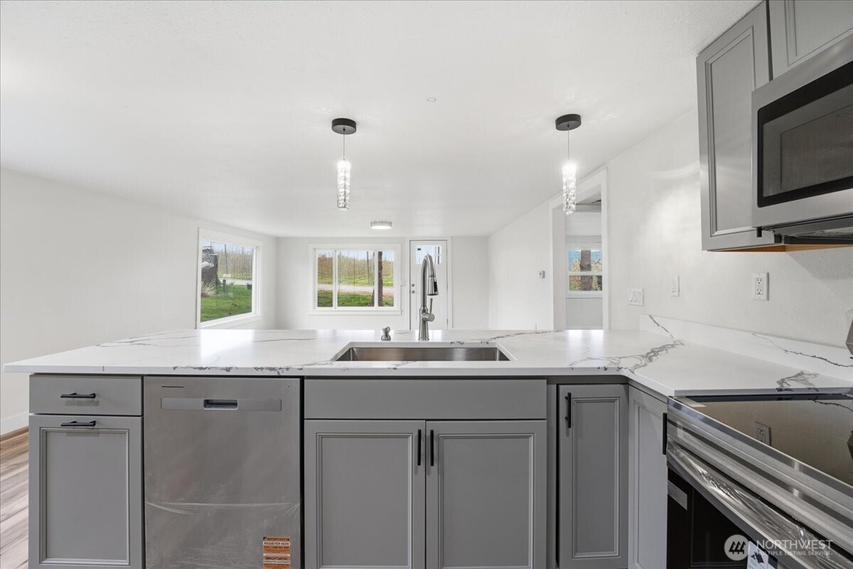 293 Barkley Road Manson, WA 98831 - Photo 11 of 40 a kitchen with cabinets appliances and a sink