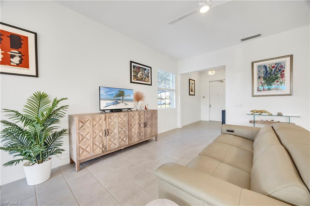 4708 Rio Poco Court Naples, FL 34109 - Photo 12 of 37 Tiled living room featuring ceiling fan