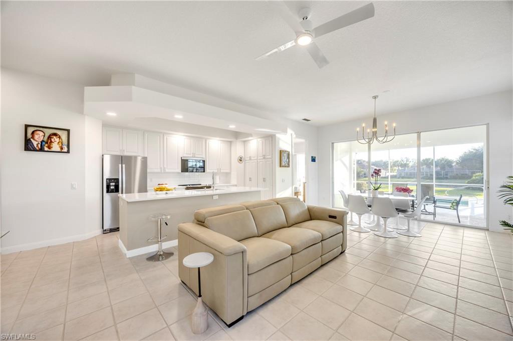 4708 Rio Poco Court Naples, FL 34109 - Photo 14 of 37 Living room with a ceiling fan, a chandelier, light tile patterned floors, and recessed lighting