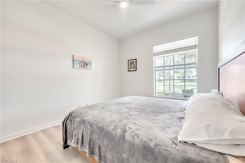 4708 Rio Poco Court Naples, FL 34109 - Photo 20 of 37 Bedroom with wood finished floors and ceiling fan