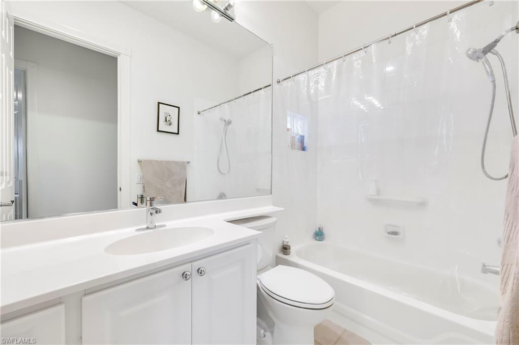 4708 Rio Poco Court Naples, FL 34109 - Photo 21 of 37 Bathroom with vanity and shower / bath combo with shower curtain