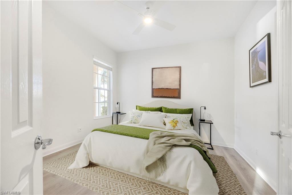 4708 Rio Poco Court Naples, FL 34109 - Photo 23 of 37 Bedroom with light wood finished floors and ceiling fan