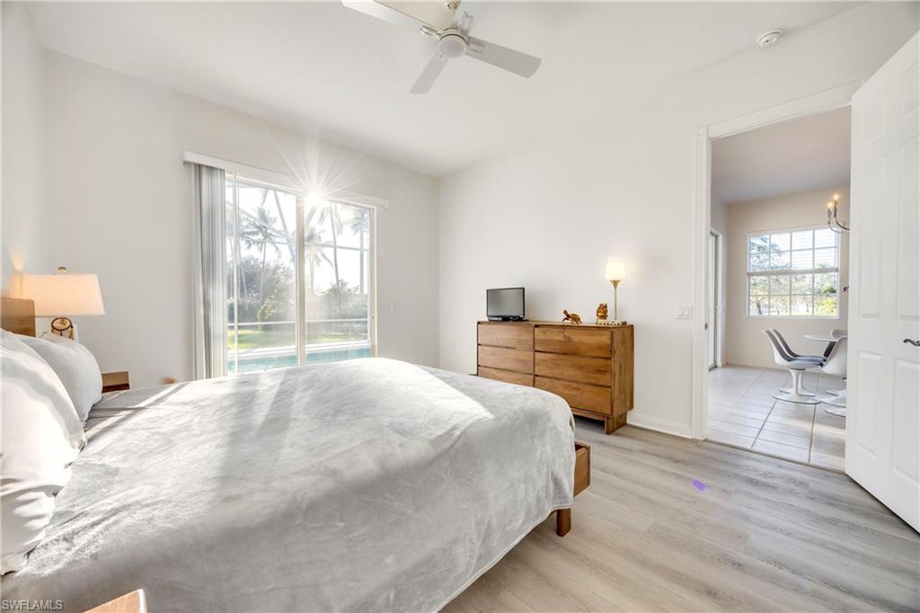 4708 Rio Poco Court Naples, FL 34109 - Photo 25 of 37 Bedroom featuring light wood-style flooring, access to outside, ceiling fan, and multiple windows