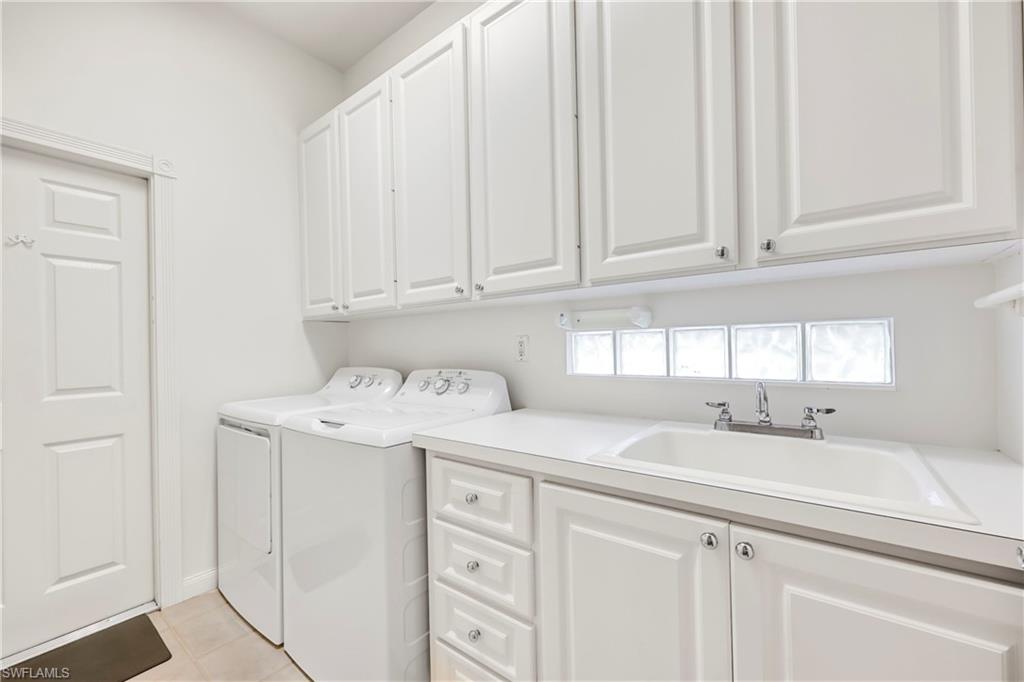 4708 Rio Poco Court Naples, FL 34109 - Photo 29 of 37 Laundry area featuring washer and clothes dryer and cabinet space