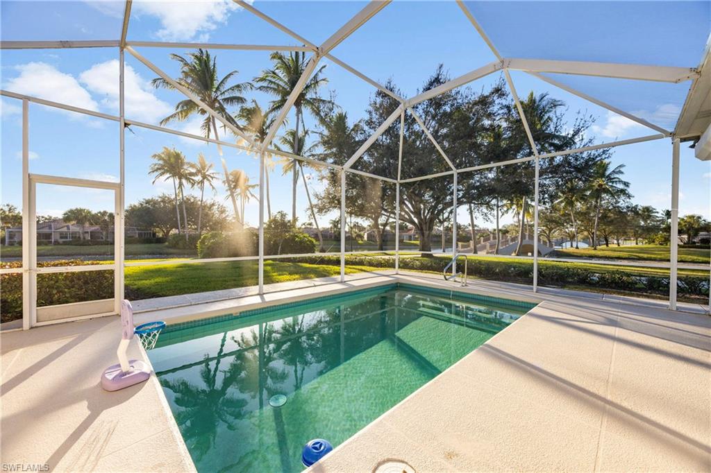 4708 Rio Poco Court Naples, FL 34109 - Photo 31 of 37 Swimming pool featuring screen, a sunroom, and a lawn