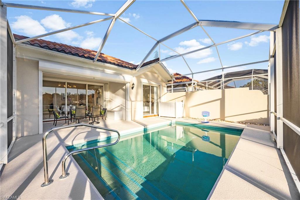 4708 Rio Poco Court Naples, FL 34109 - Photo 32 of 37 Swimming pool featuring a sunroom, glass enclosure, and a patio