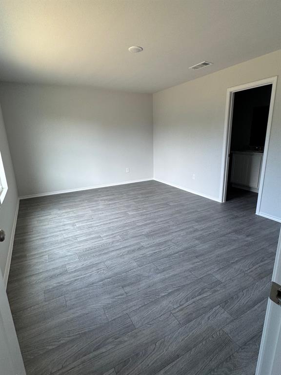 350 Azalea Trail Granbury, TX 76048 - Photo 13 of 18 a view of an empty room with wooden floor