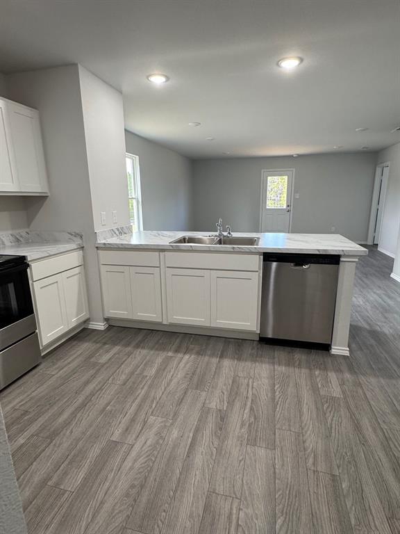 350 Azalea Trail Granbury, TX 76048 - Photo 7 of 18 a kitchen with stainless steel appliances granite countertop a stove a sink and a refrigerator