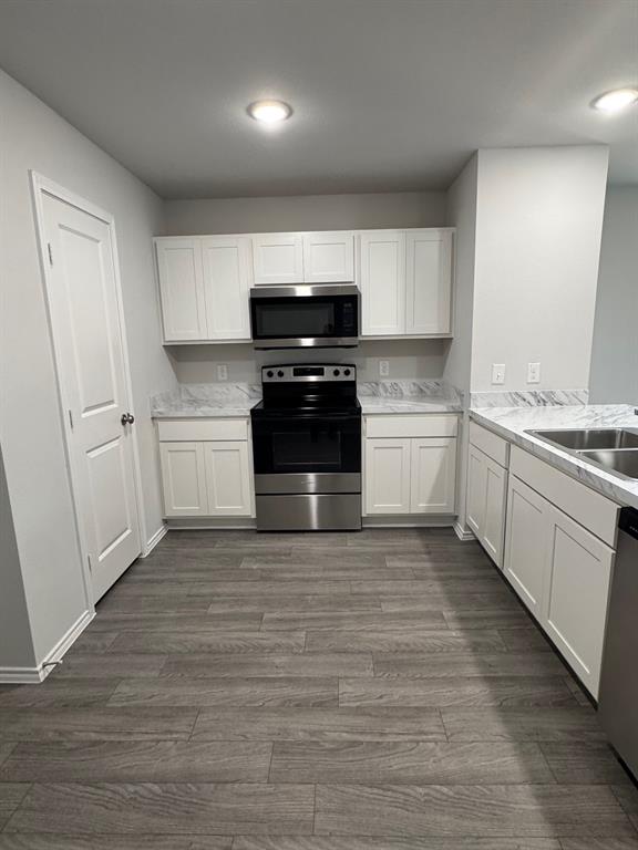 350 Azalea Trail Granbury, TX 76048 - Photo 8 of 18 a kitchen with a sink and a stove top oven