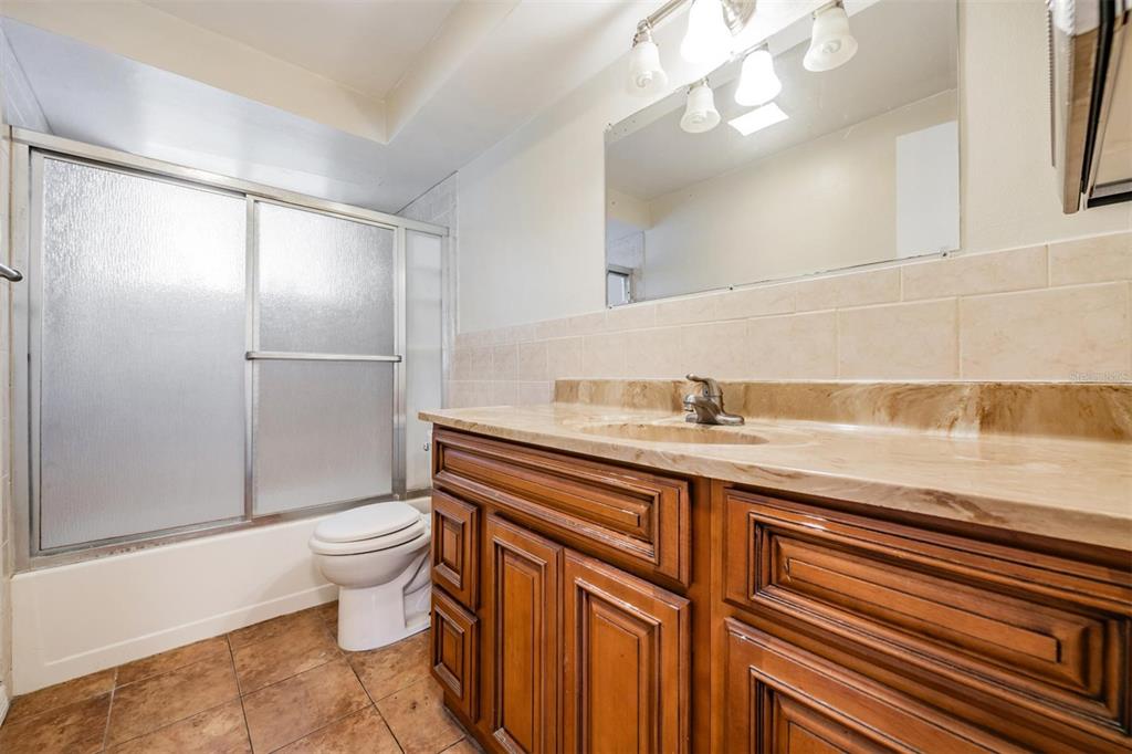 10810 Leeds Road Port Richey, FL 34668 - Photo 16 of 29 Tub/shower bathroom near primary bedroom